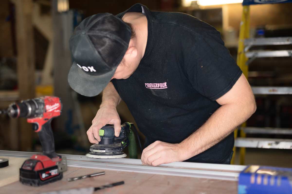 Man sanding wood in workshop