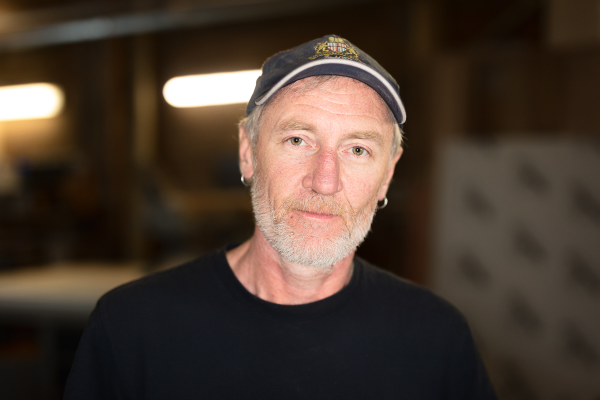 Man with a cap in a workshop.
