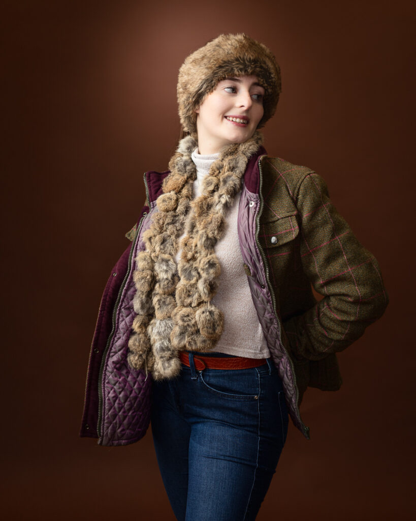 Woman in stylish winter clothing, smiling.