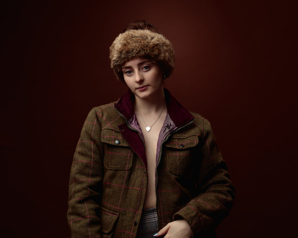 Person in a plaid jacket and furry hat.
