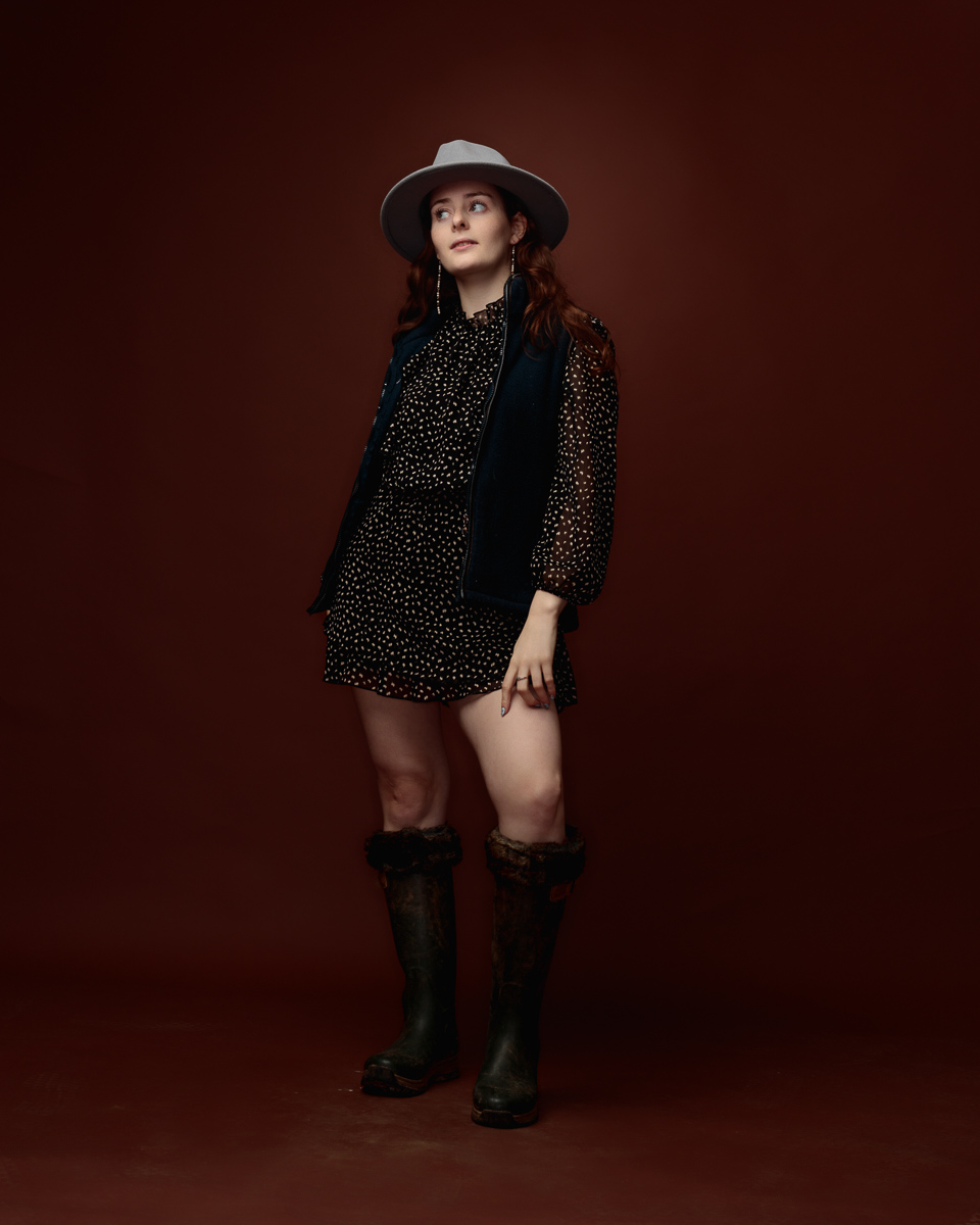 Woman wearing polka dot dress and hat indoors