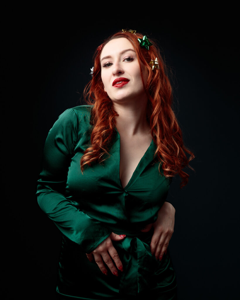 Person in green dress with festive hair decorations.
