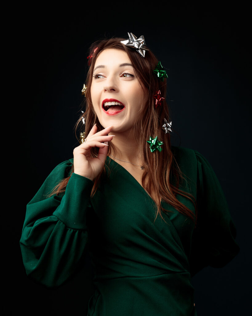 Woman with Christmas bows, festive green dress