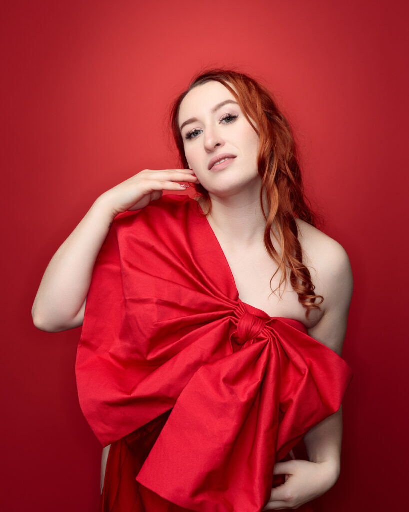 Woman in red dress on red background.
