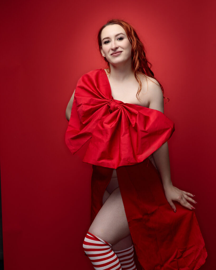 Person in red dress and striped socks posing