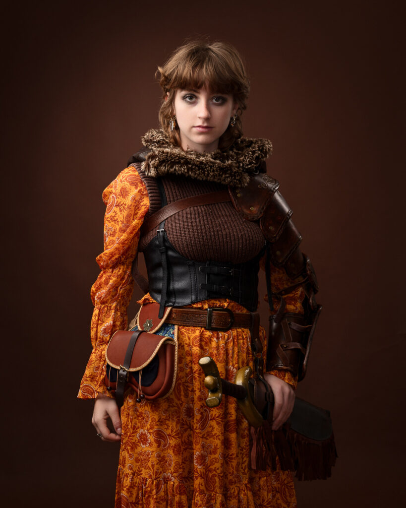 Person in medieval-inspired costume with armour and accessories.