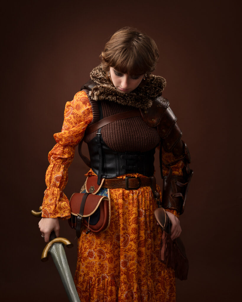 Person in medieval armour holding a sword.