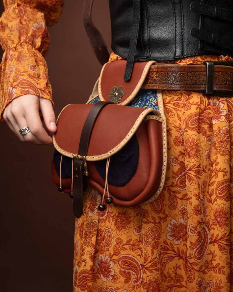 Vintage leather bag with floral dress details.