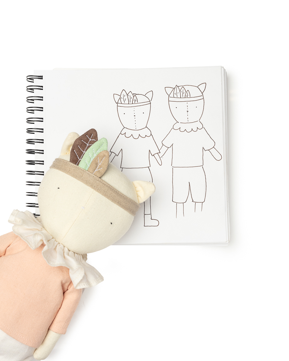 Plush toy and sketchbook with drawings.