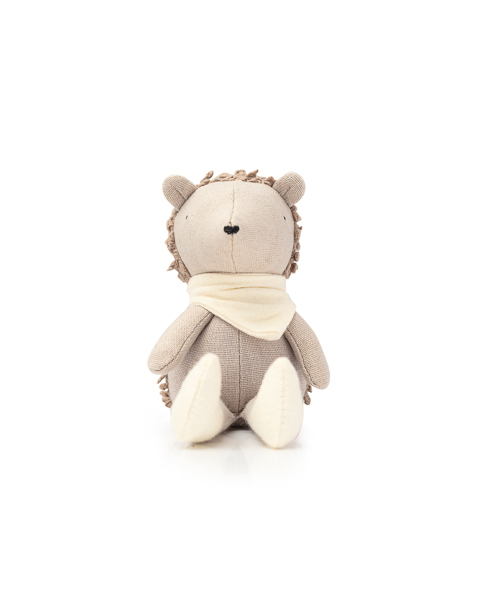 Plush hedgehog toy with scarf, isolated on white.