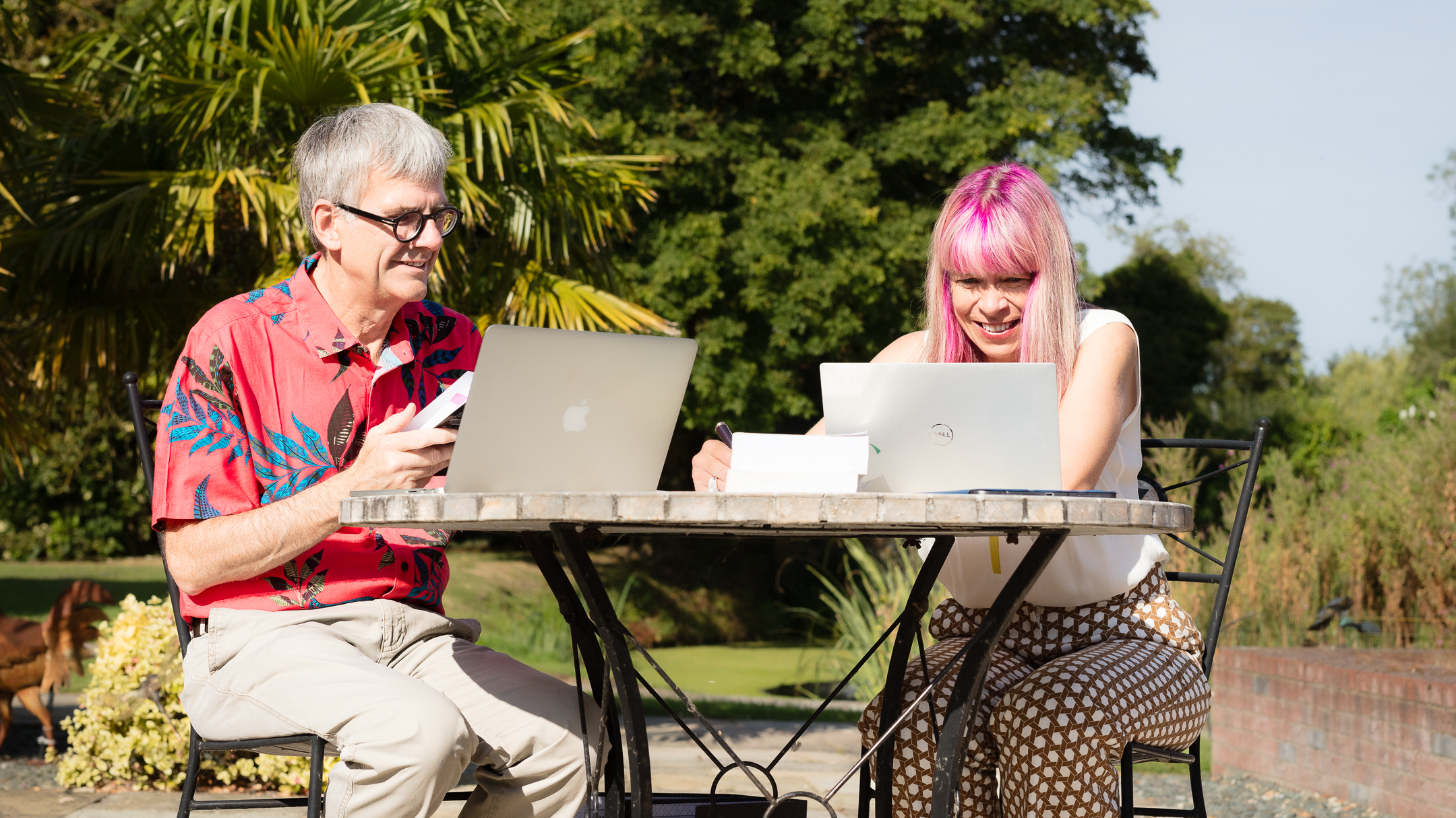 Personal branding photograph for FHM Forensic Accounting, two colleagues working on laptops at a garden table