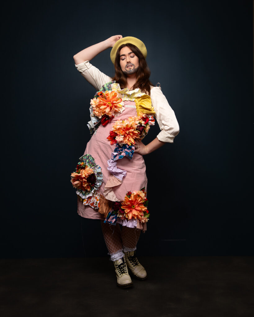 Person in floral dress with a beret poses