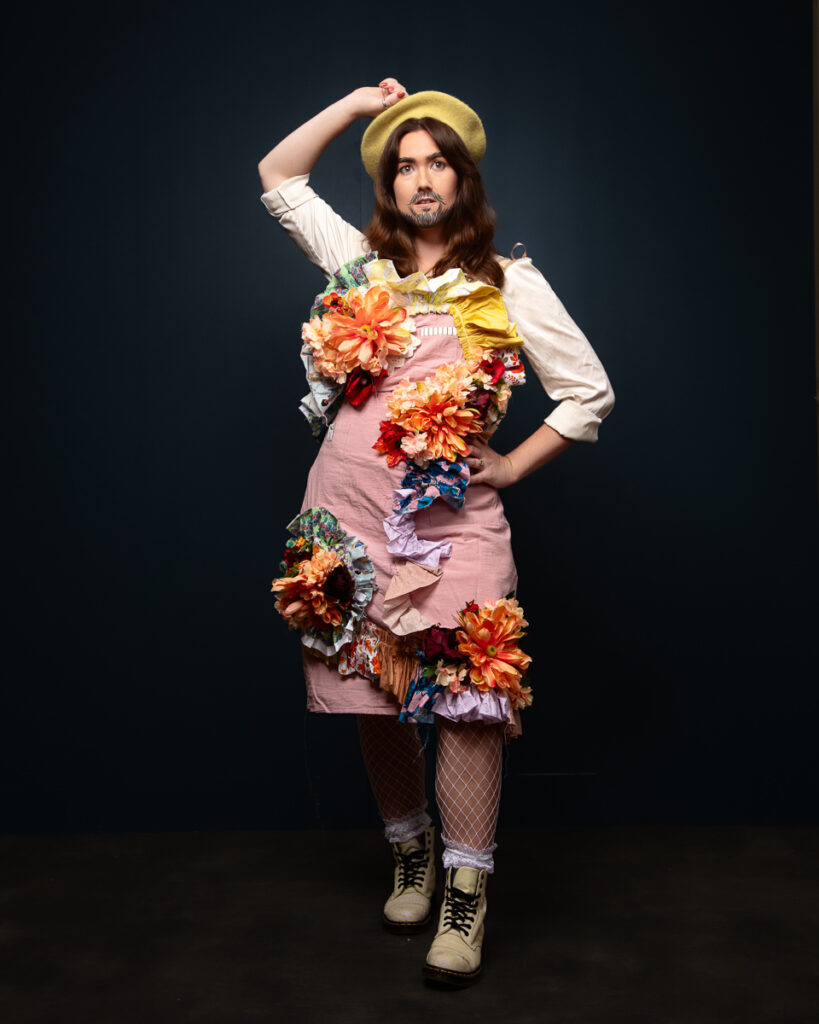 Person in floral dress posing confidently