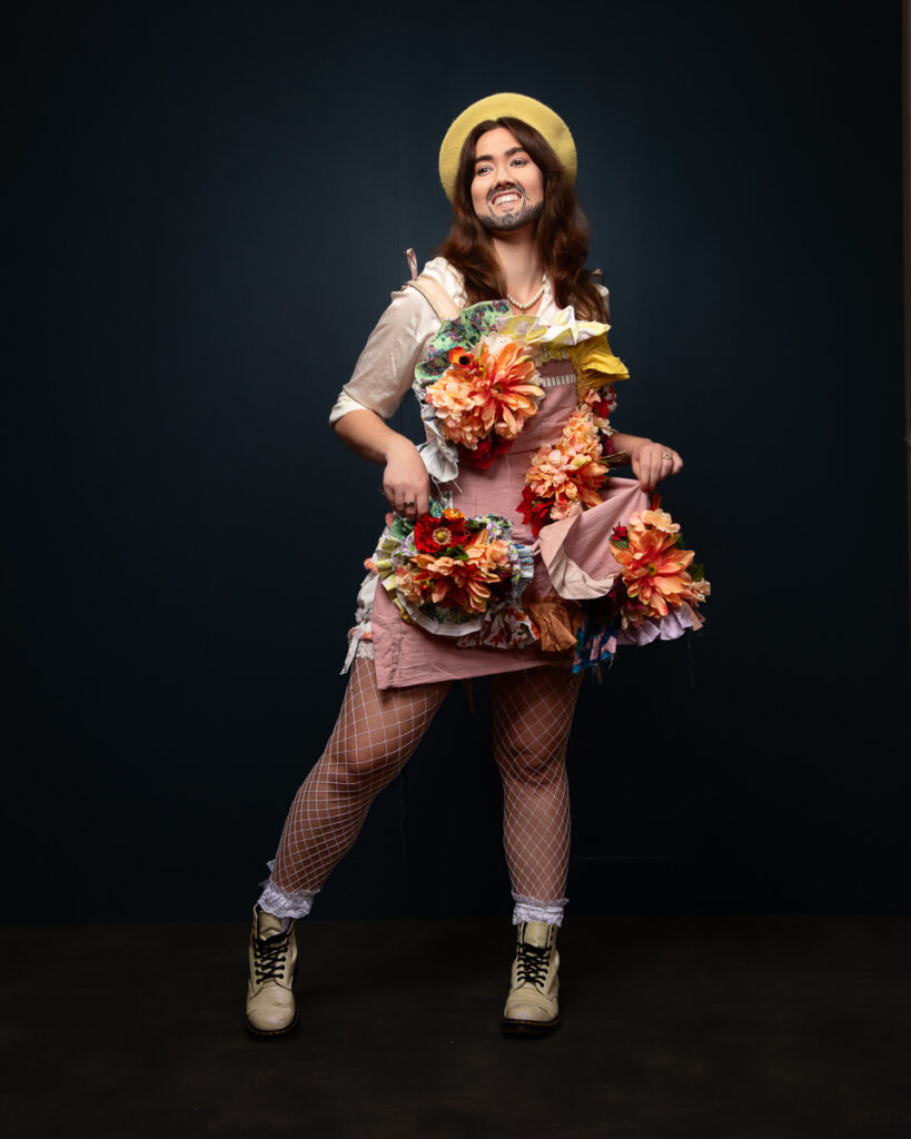 Person wearing artistic floral costume with net stockings.
