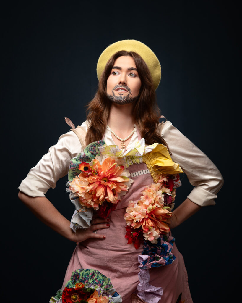 Person posing in floral costume with painted beard