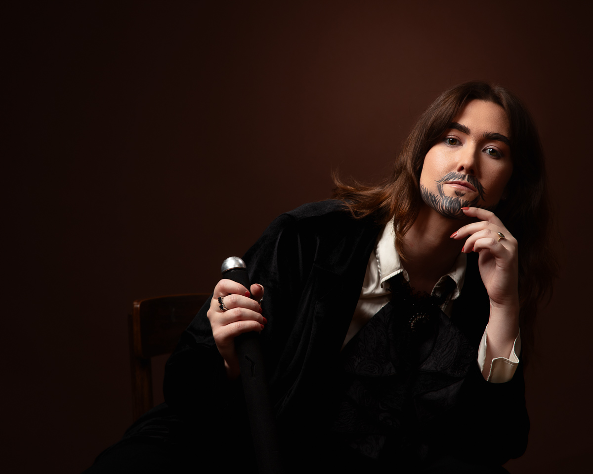Person in costume with a thoughtful pose.