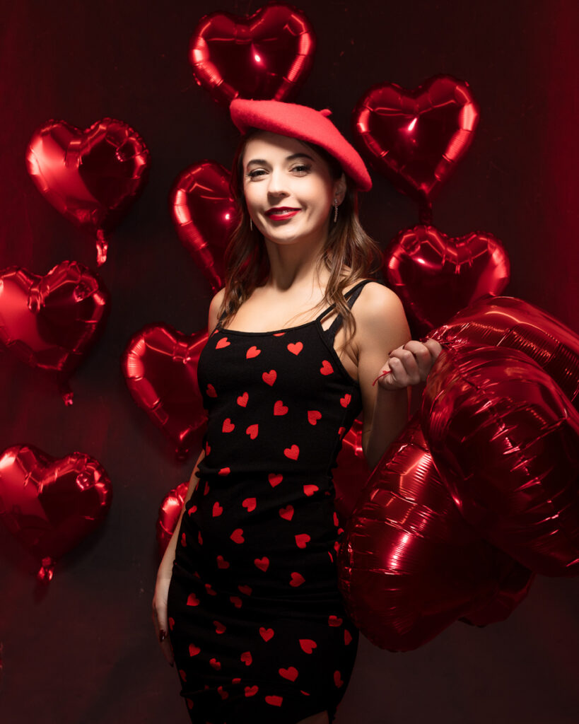 Woman with heart balloons and red beret