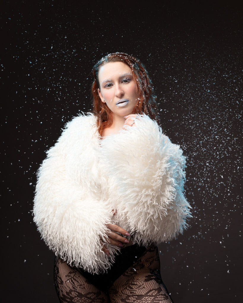 Woman in fluffy coat with snow effect.
