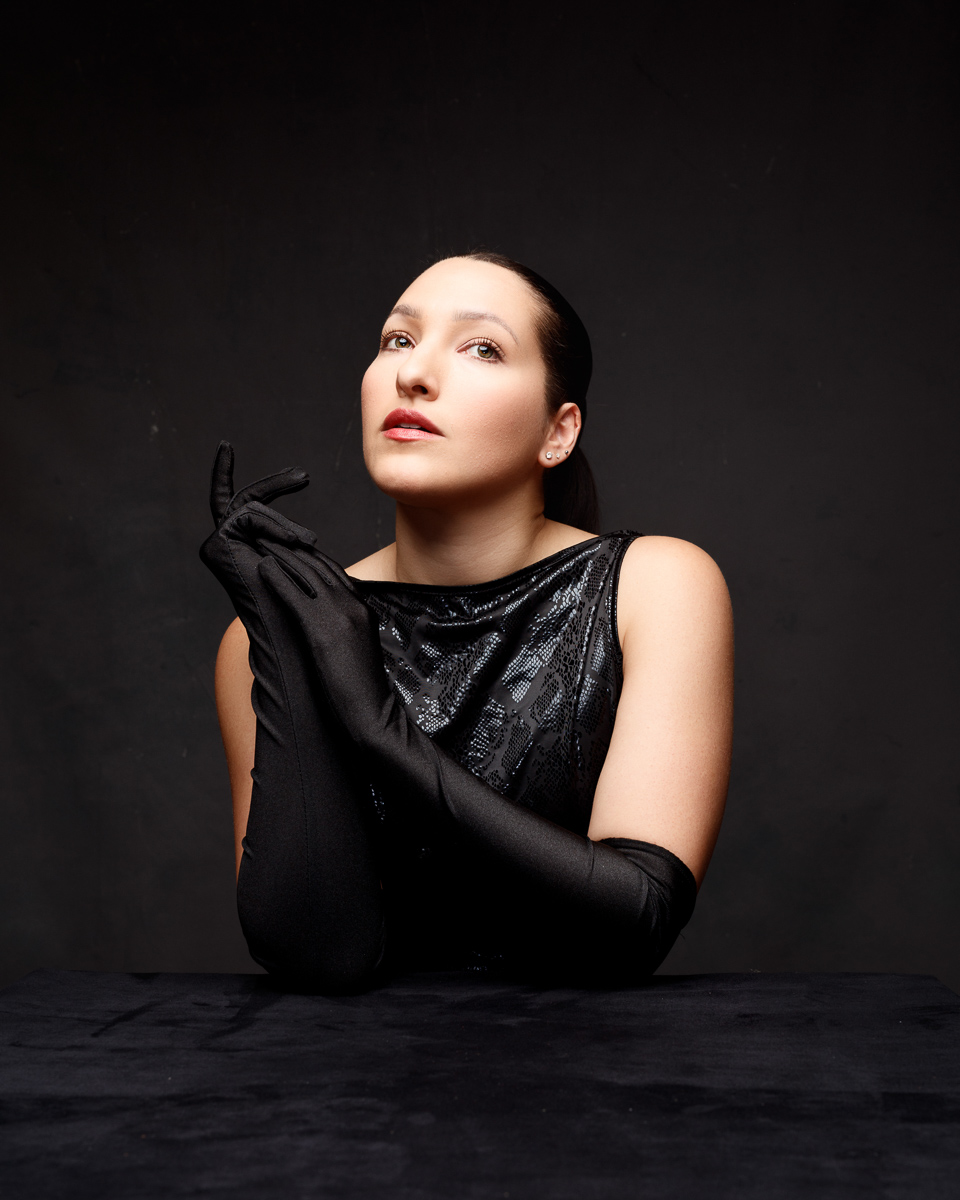 Woman in black dress and gloves, elegant pose