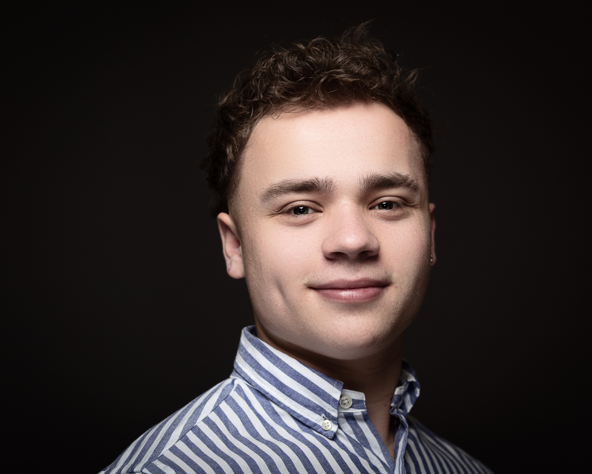 Smiling person in striped shirt.