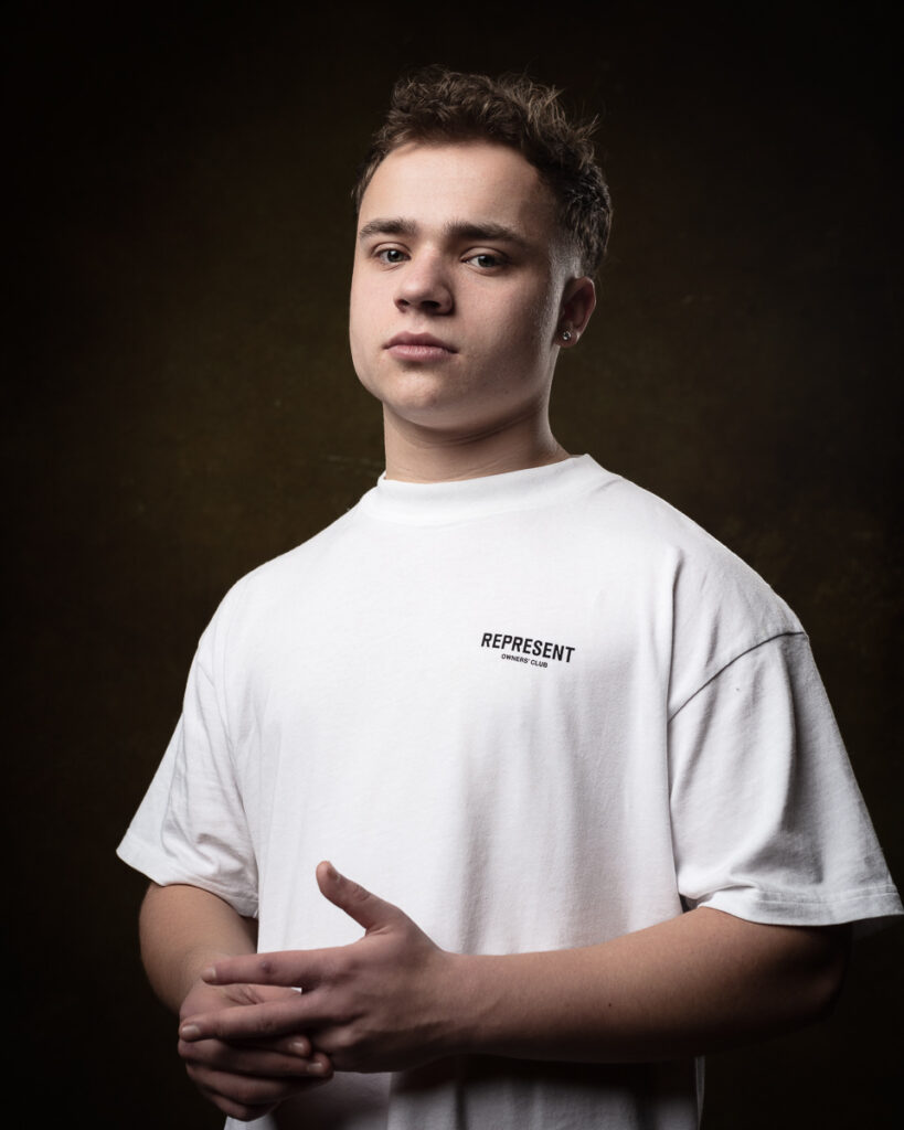 Person in white shirt against dark background