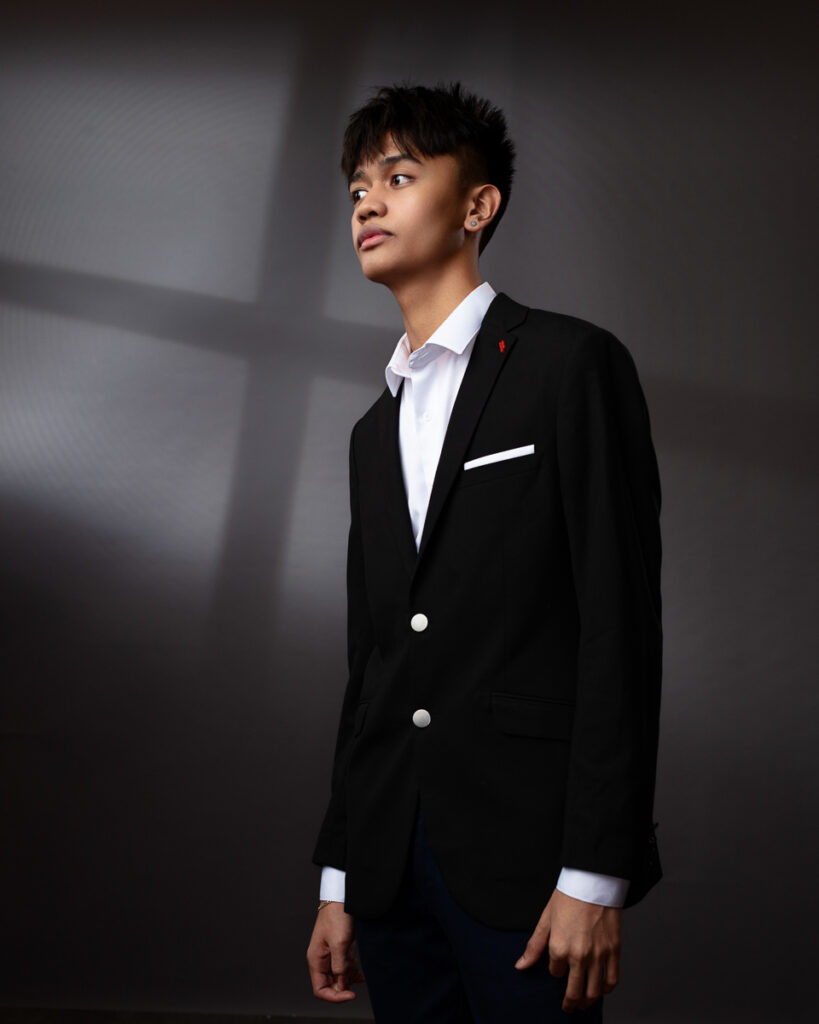 Young man in stylish black suit, contemplative pose