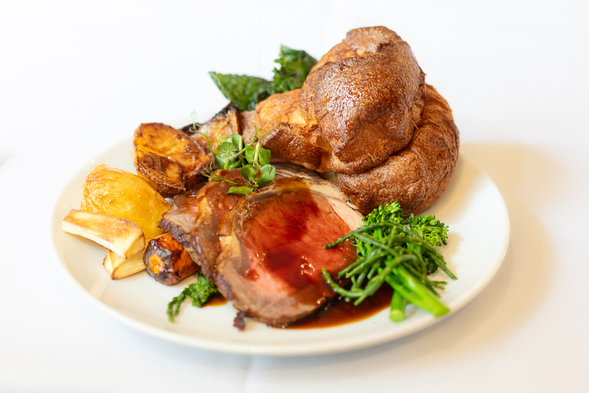 Roast beef dinner with Yorkshire pudding on a white plate at Seckford Hall