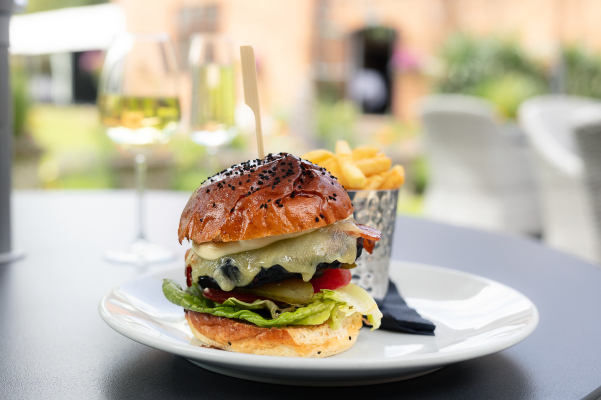 Burger with chips and a glass of white wine at Seckford Hall