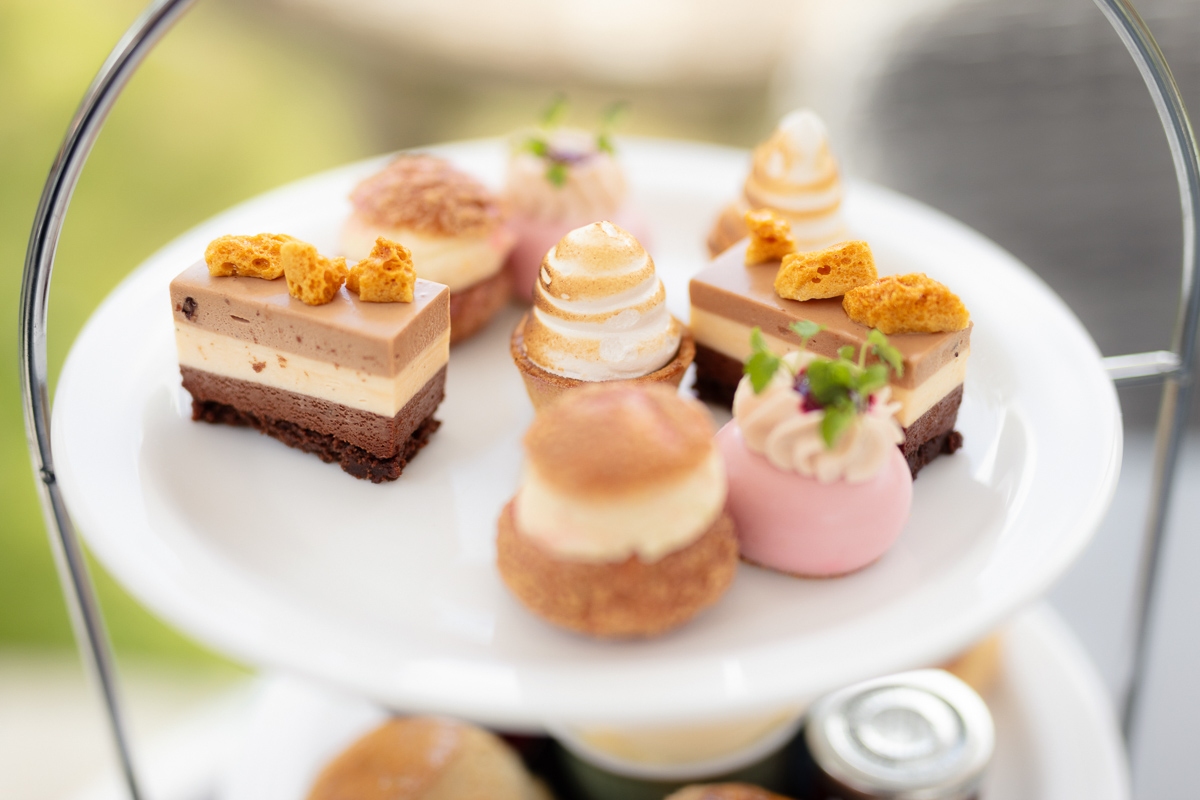Afternoon tea cakes and pastries on a white stand at Seckford Hall