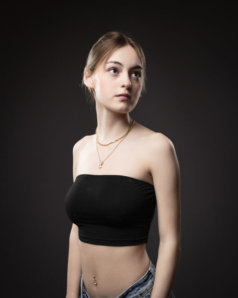 Woman in black tube top with jewellery.