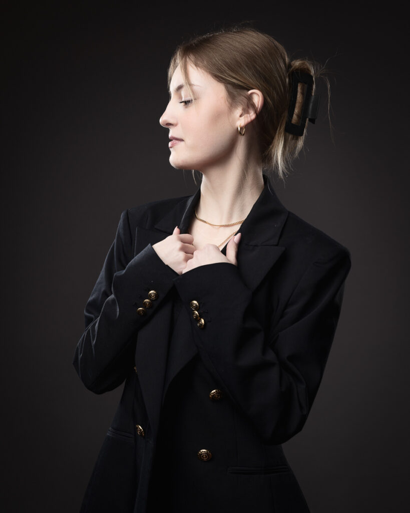 Woman posing in a formal black blazer