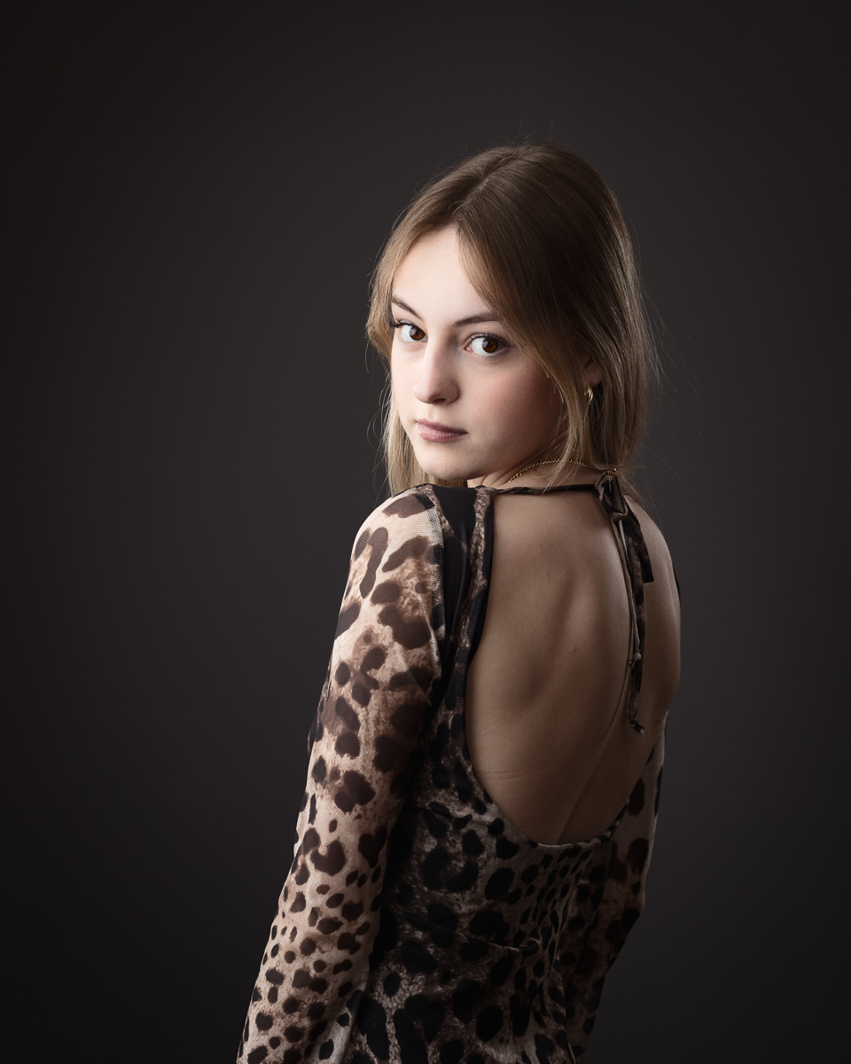 Woman in leopard print dress, back turned