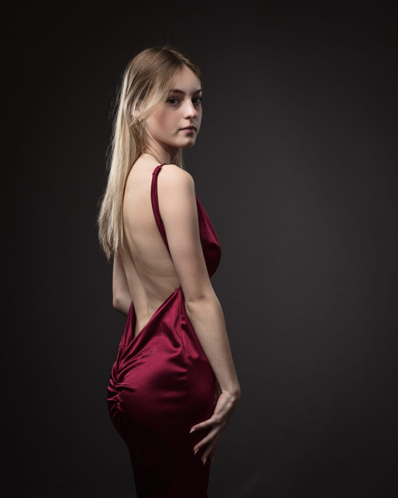 Person in elegant red satin dress.