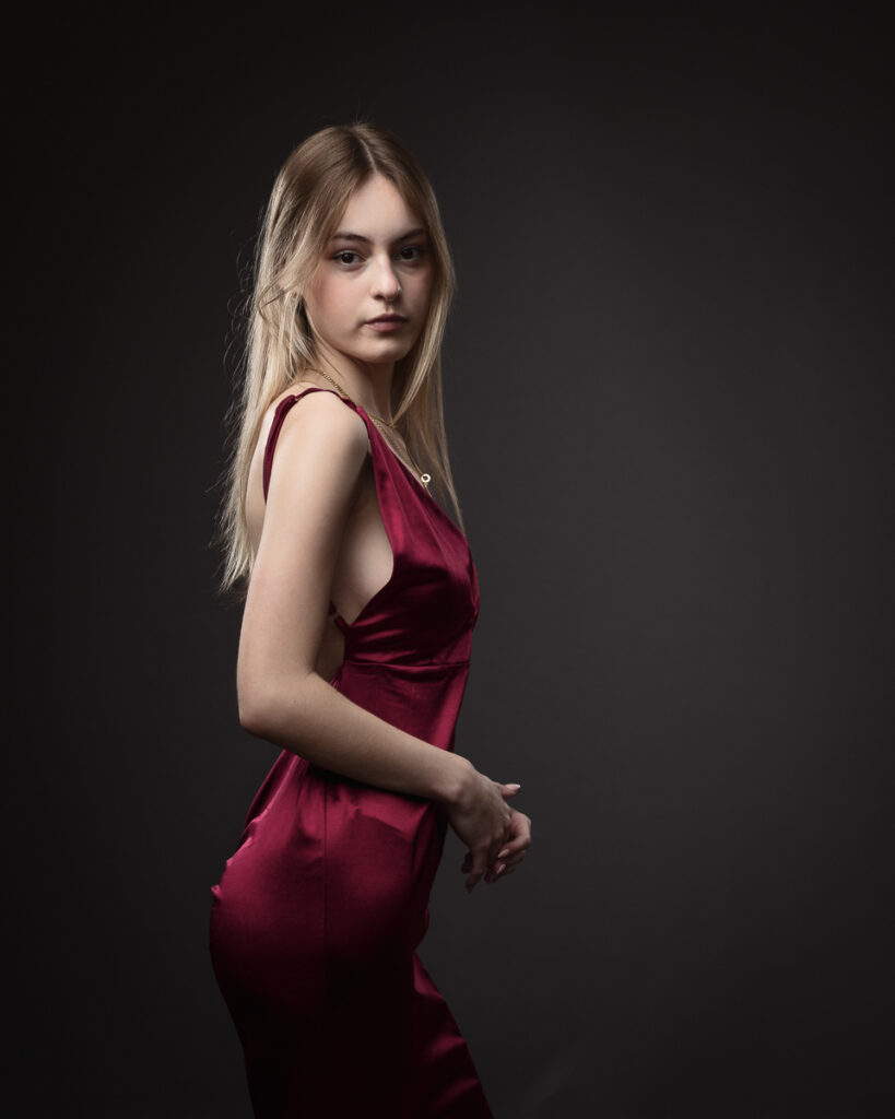 Model in red dress posing elegantly
