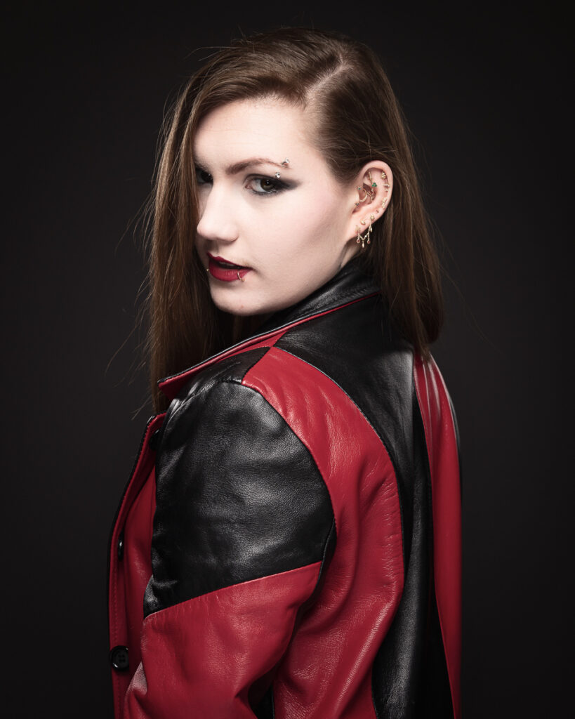 Woman in red leather jacket with piercings