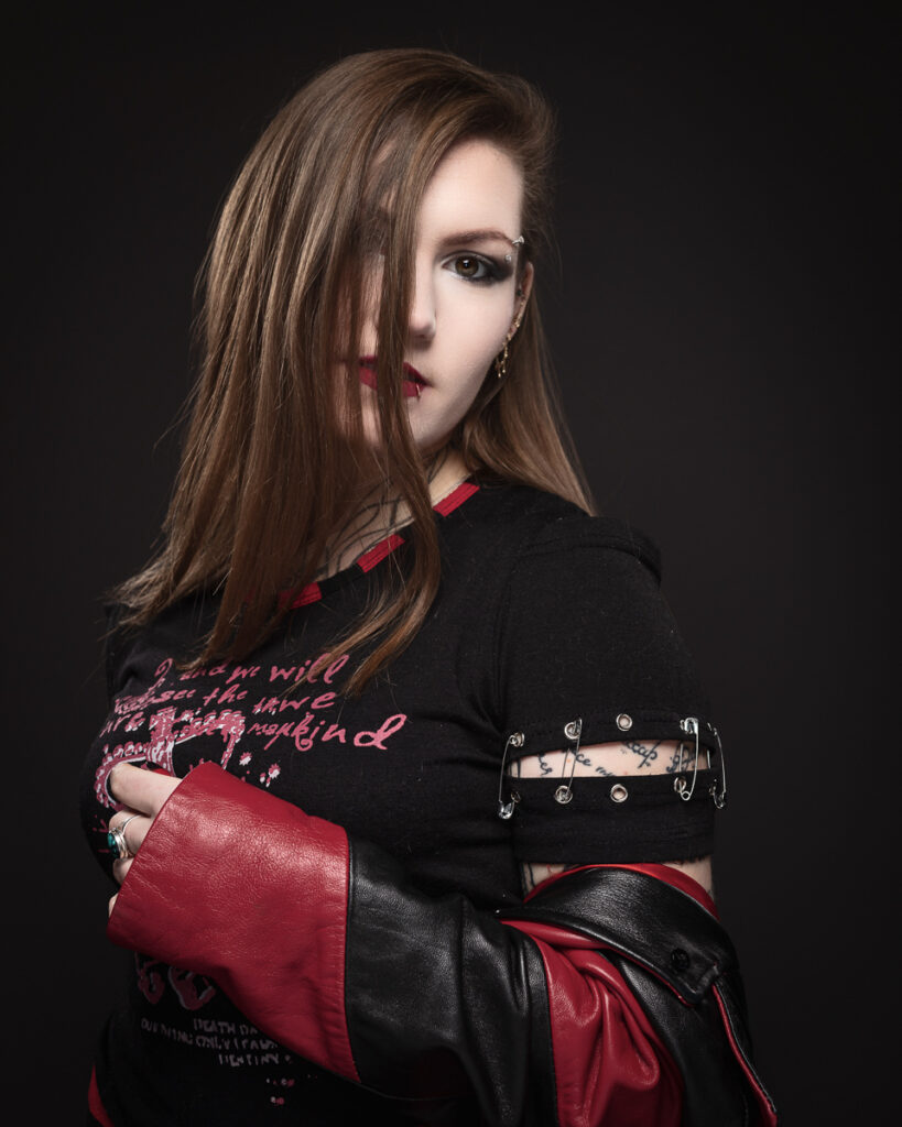 Person with edgy style, leather jacket, and piercings