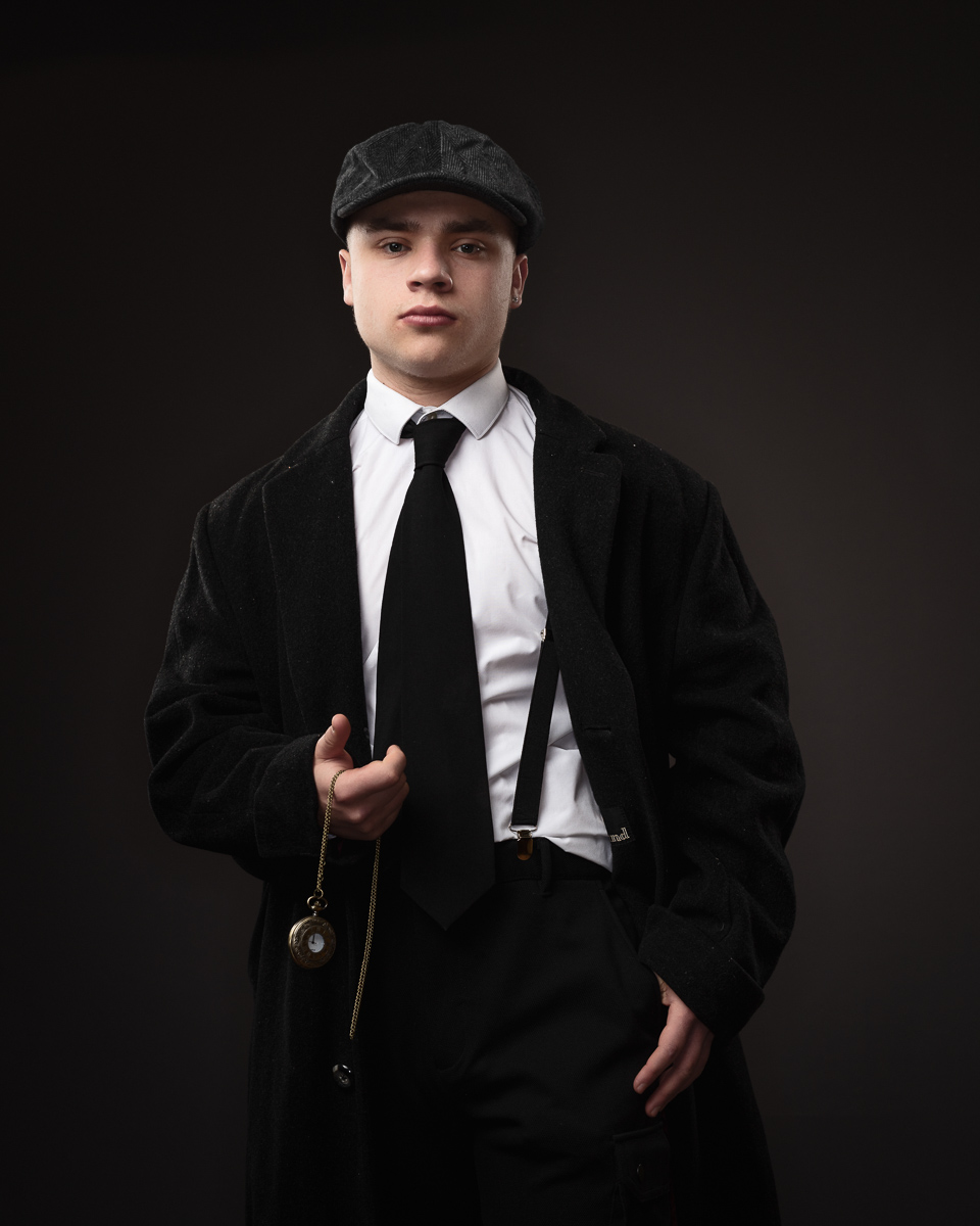 Man in vintage suit holding pocket watch