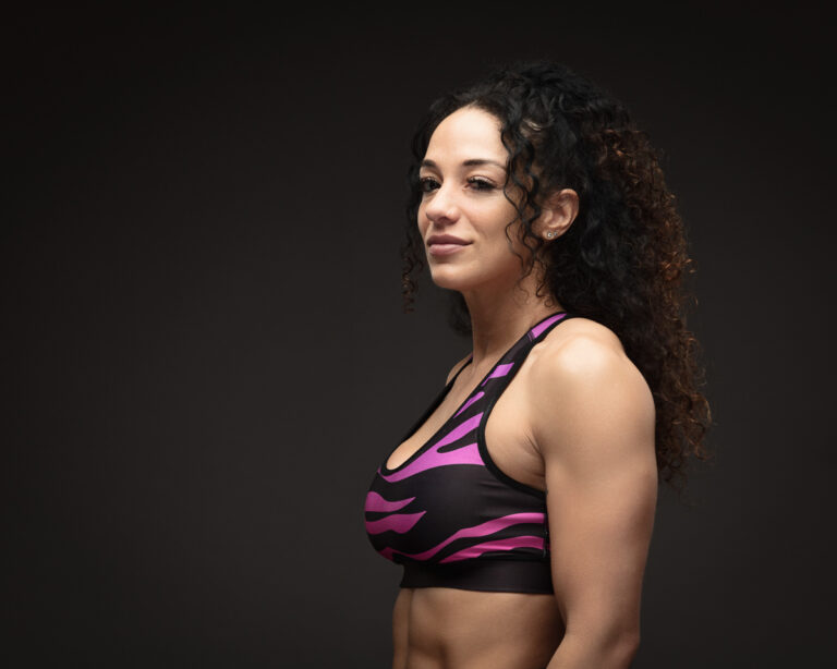 Fit woman in workout attire posing confidently.