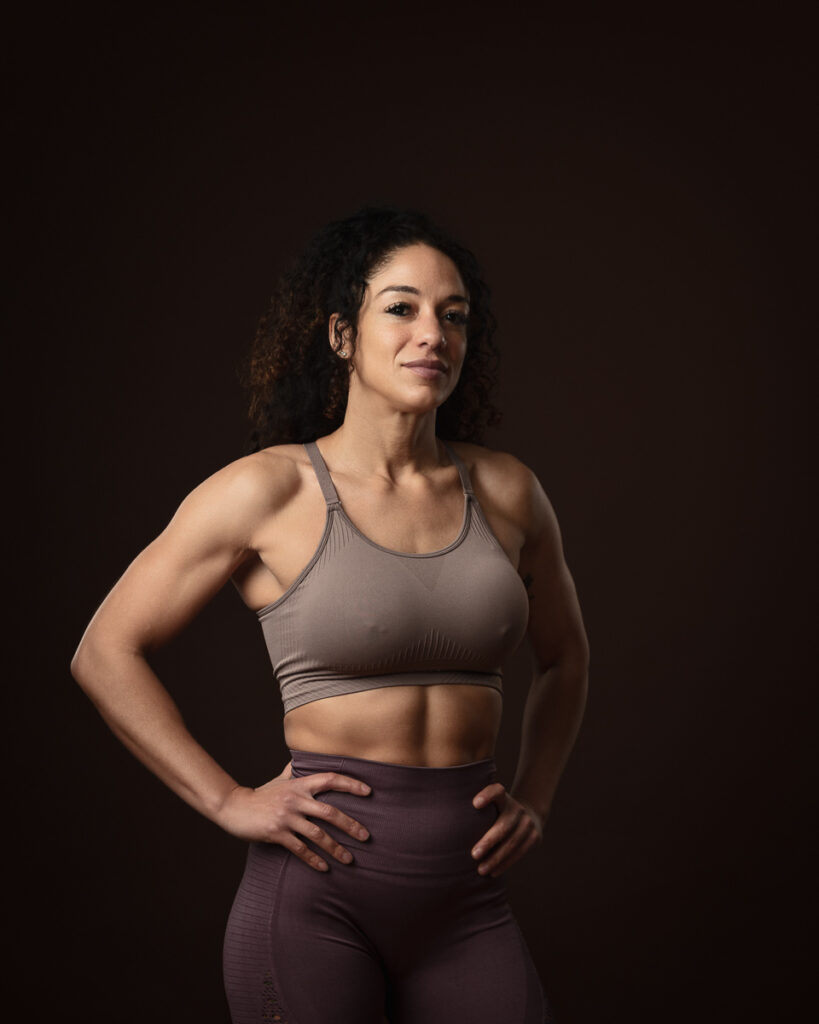 Confident woman in fitness attire posing.