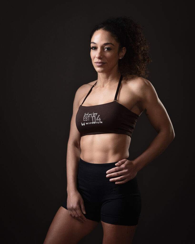 Woman in athletic wear posing confidently.