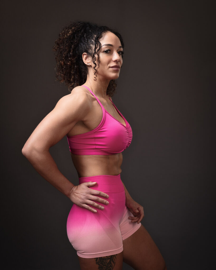 Woman posing in pink athletic wear.