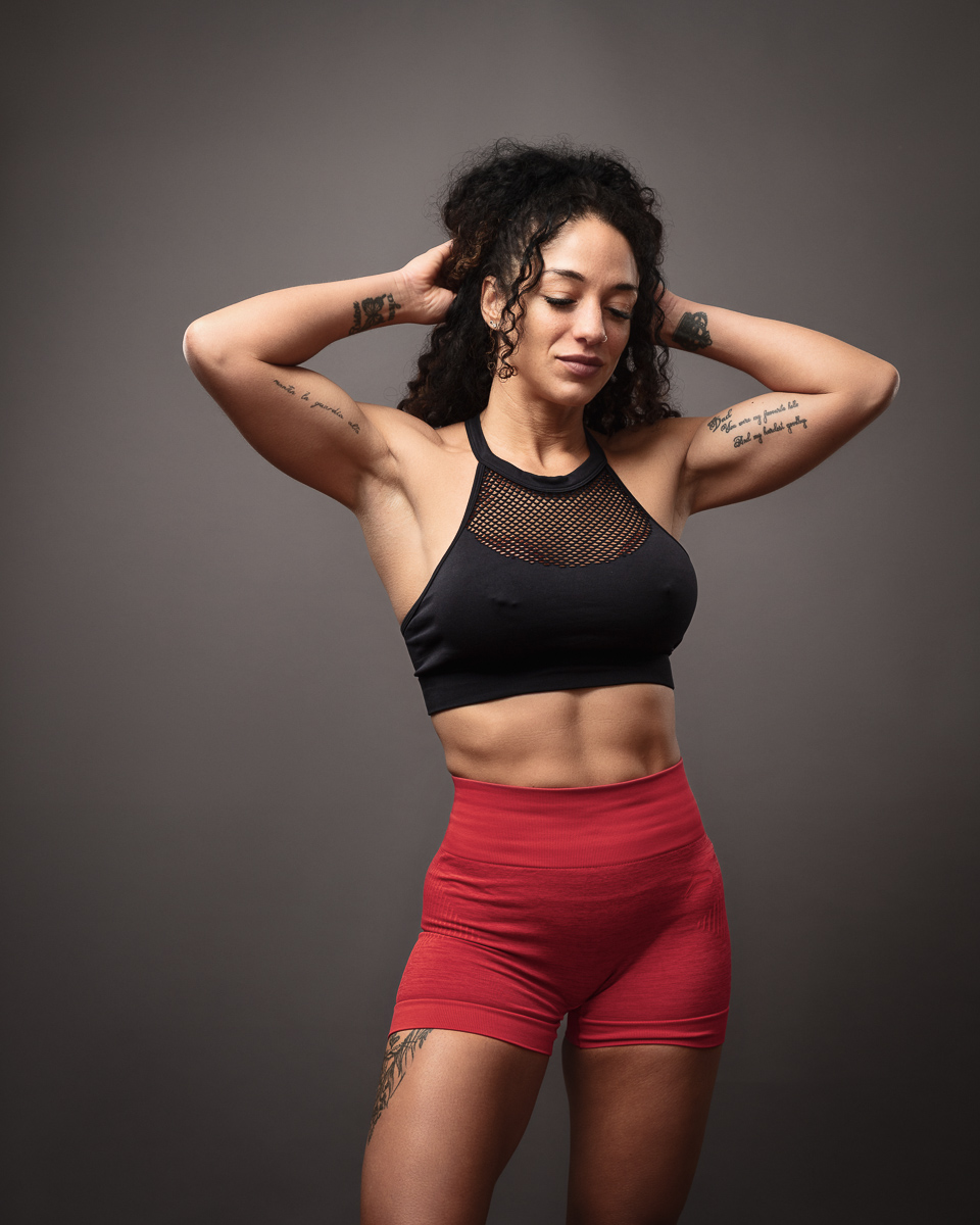 Woman in fitness attire striking a pose.