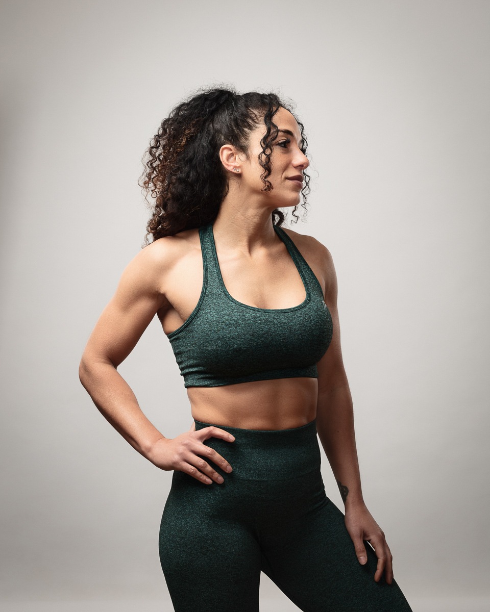 Athletic woman in workout gear, side pose.