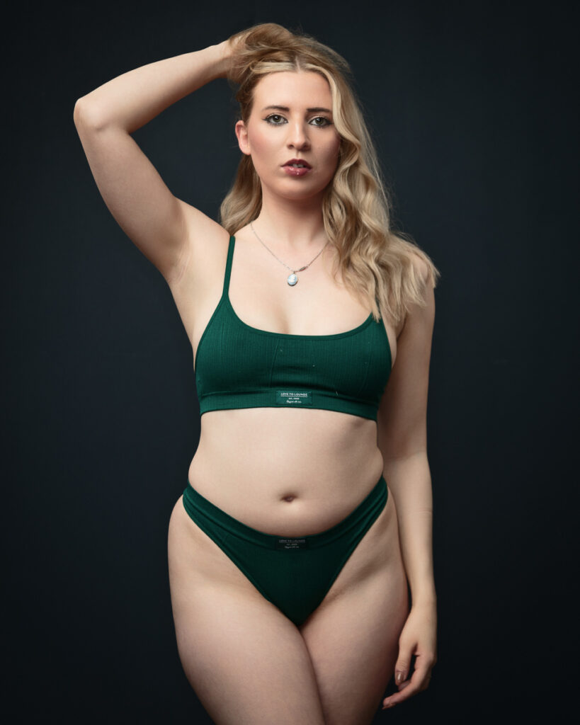 Woman in green bikini posing confidently