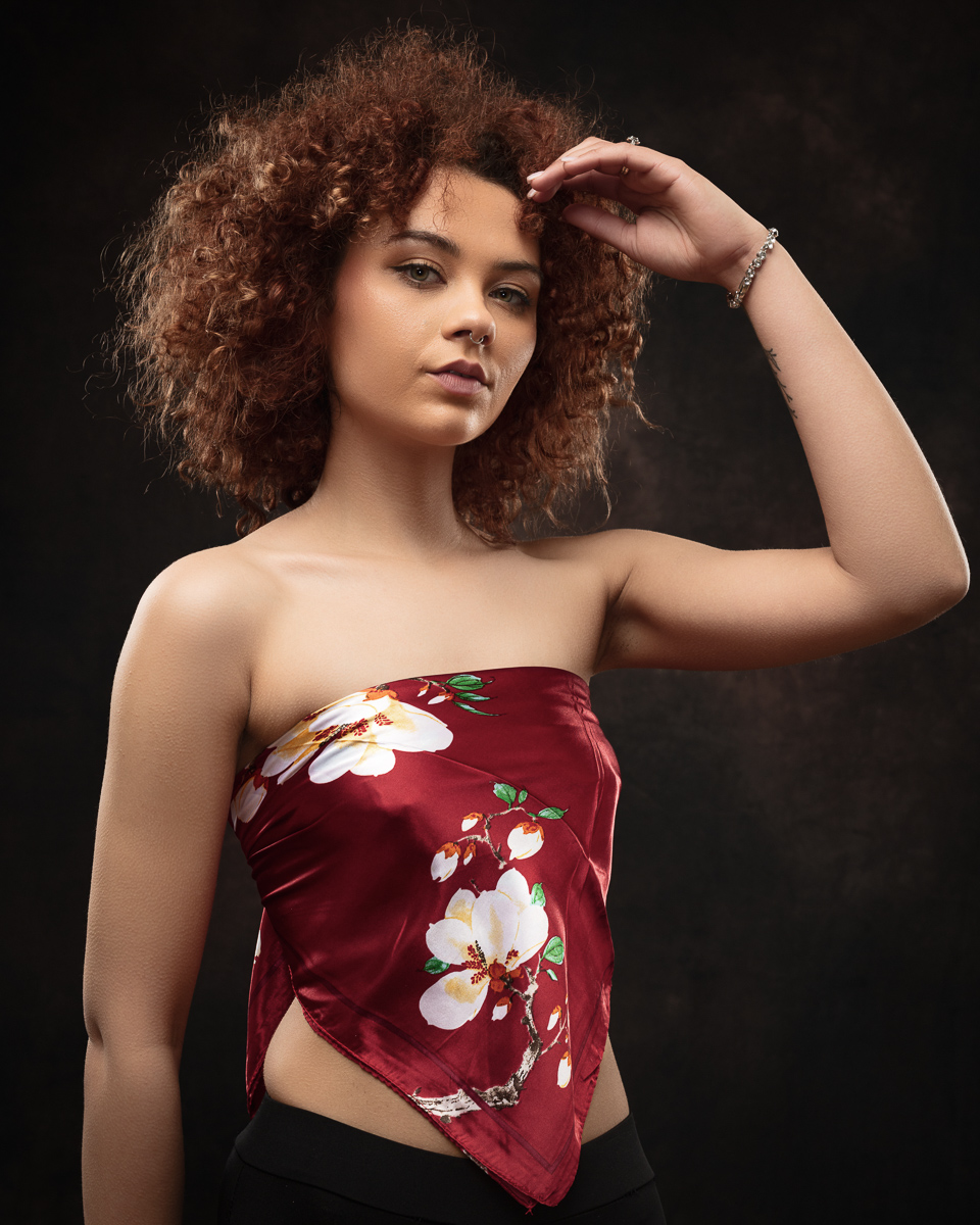 Woman in floral top with curly hair