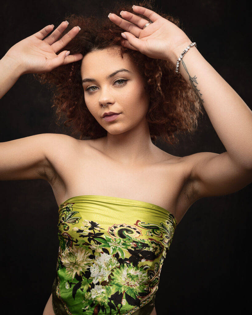 Woman posing gracefully in floral top