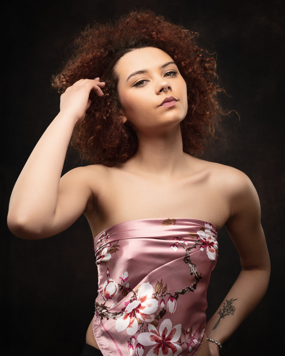 Woman with curly hair in floral top