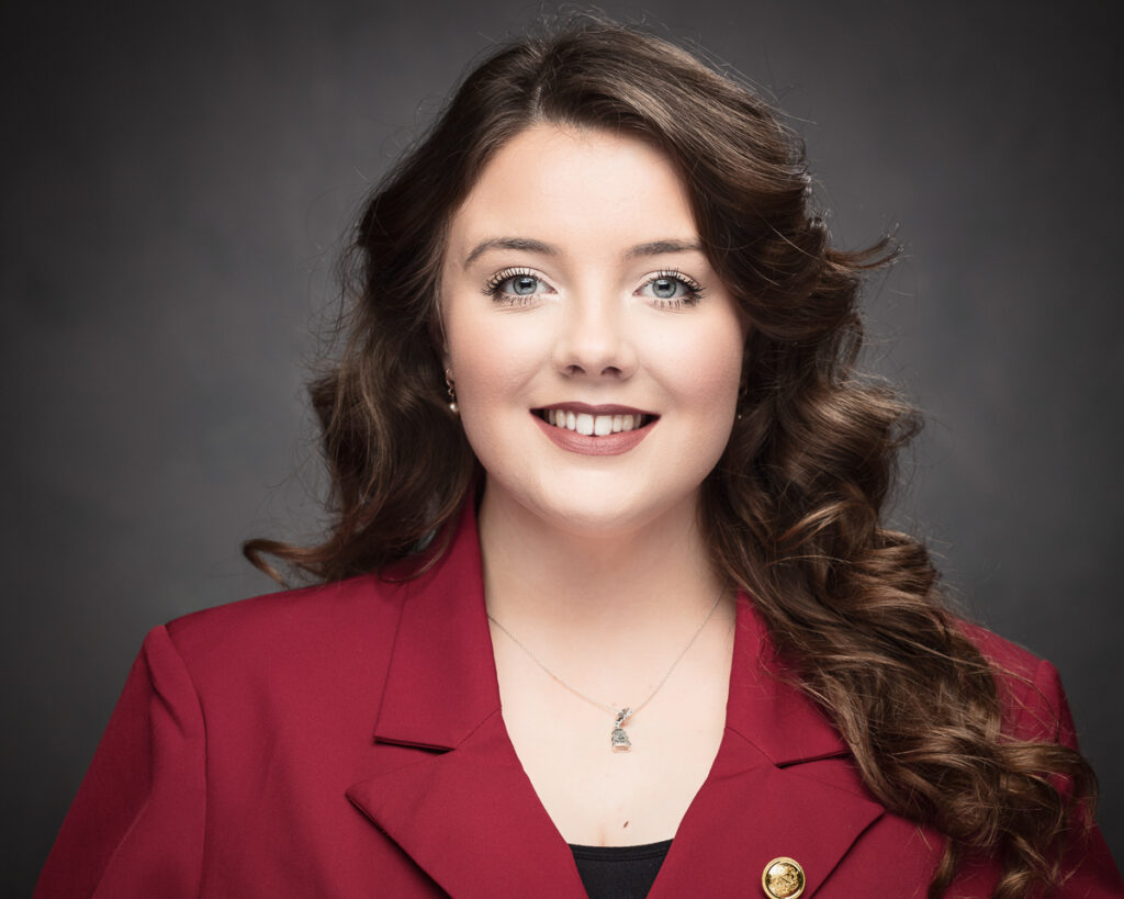Woman in red blazer smiling portrait