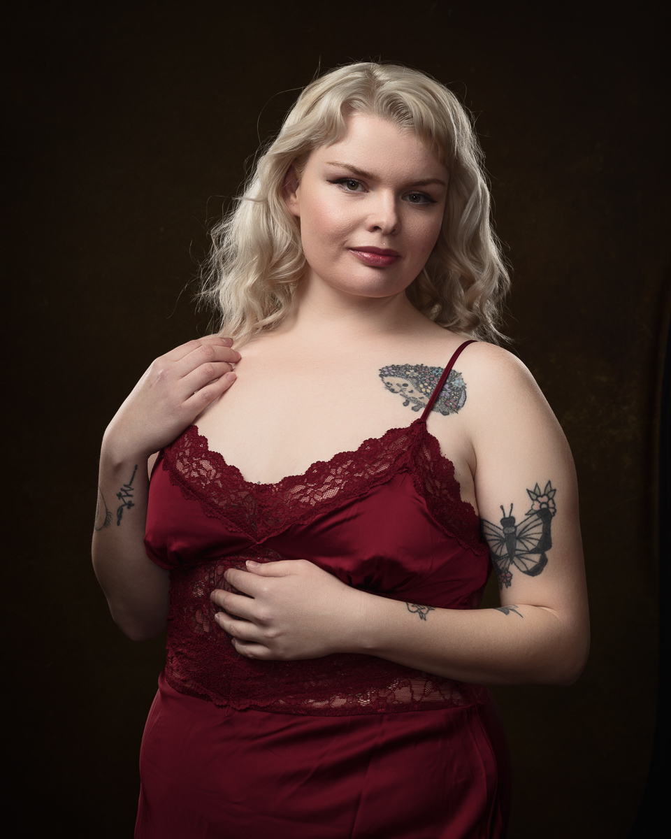 Woman in red lace dress with tattoos.