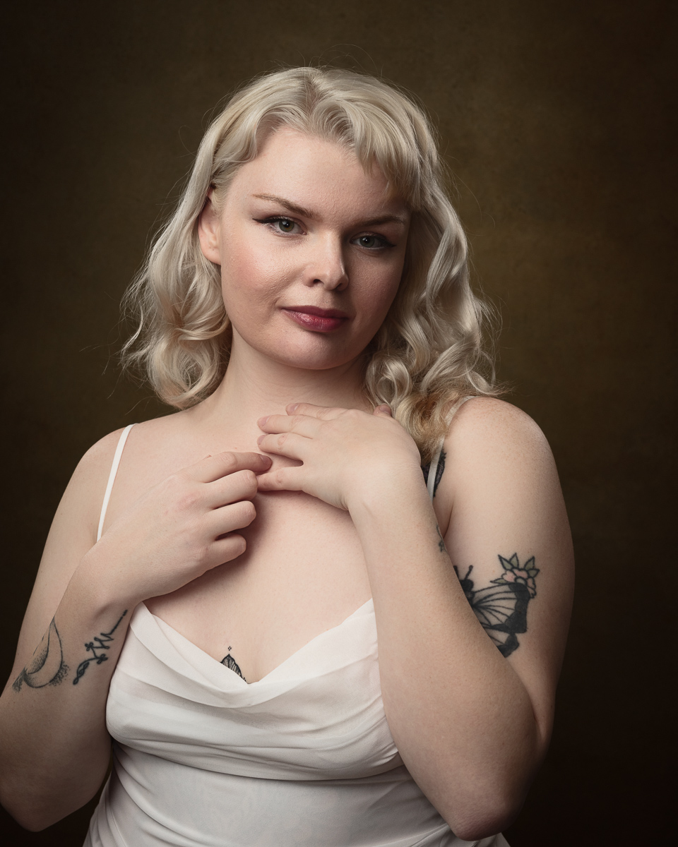 Smiling woman with tattoos and blonde hair